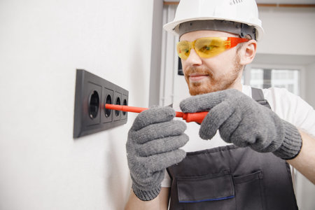 Electrician install switches and sockets screwdriver tool working at home