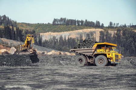 Open pit mine industry. Yellow mining truck for coal move to excavator loads