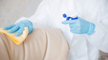 Cleaning service disinfects hotel room from coronavirus and germs. Concept antiseptic against...