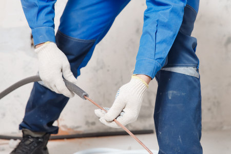 Worker man Installation of pipe channel for connecting air conditioner.