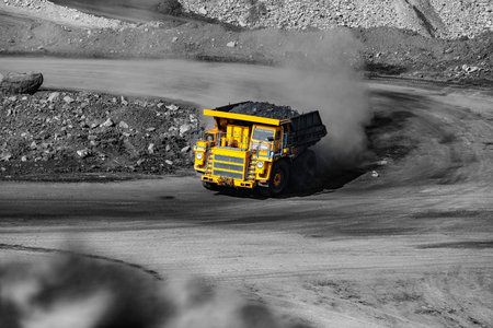 Big yellow mining truck for coal move. Open pit mine industry.