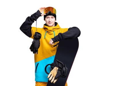 Portrait young man in sportswear safety glasses with snowboard isolated white background bannerの写真素材