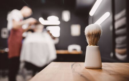 Brush for shaving beard along, blurred background of hair salon for men, barber shop.の写真素材
