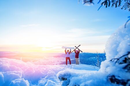 Two active friends snowboarder and skier standing on mountain top blue sky sunrise. Concept ski resort winter forest.の写真素材
