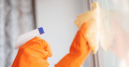 Window washing glass with cleaning agent and rag.の写真素材