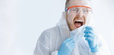 Man of house is quarantined, nervous breakdown after isolation home, tantrum and scream window. Phobia virus conceptの写真素材