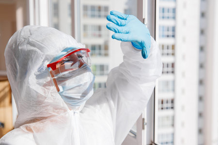 Woman biohazard patient after quarantine, looks bright sun and breathes fresh air. Concept exit from...