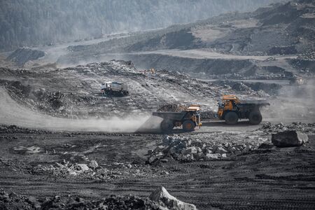 Open pit mine industry, big yellow mining truck for coal and site preparation for blastingの写真素材