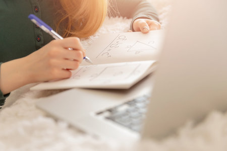 Girl schoolboy is engaged in online math lessons computer in school web chat.