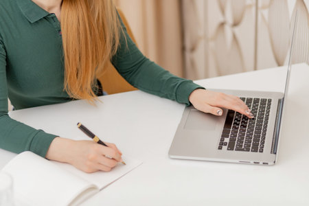 Young female student freelancer working online behind laptop home quarantine coronavirus