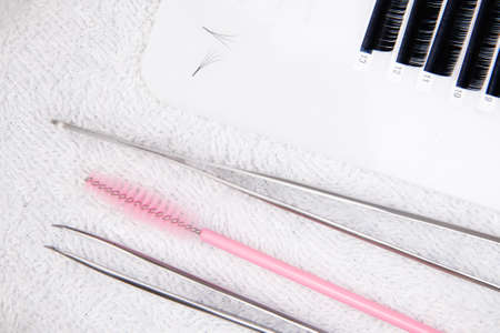 Close-up tool for eyelash extension. Master of tweezers is workingの写真素材