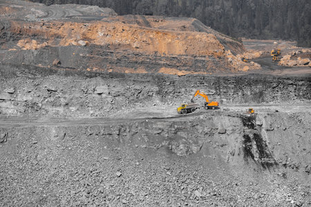 Open pit mine industry work of large yellow excavator for loading and coal mining