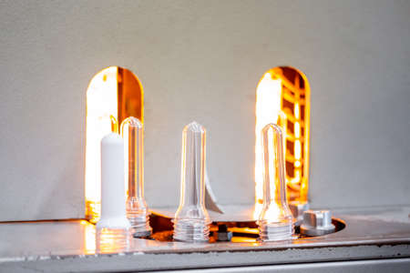 Preforms for making PET plastic bottles. Blank for production of containers for milk or beer. Line factory industry equipmentの写真素材