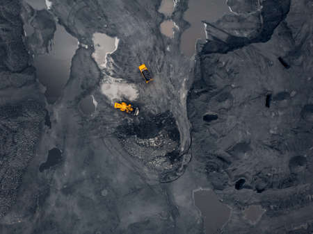 Transporting coal on yellow large dump truck. Open pit mine industry Top aerial viewの写真素材
