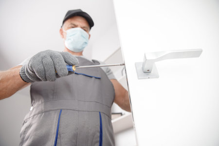 Worker in medical mask use silicone tube gun for repairing and installing window. Concept service...