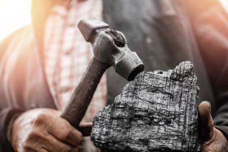 Miner holds coal palm. Concept mining. Top view