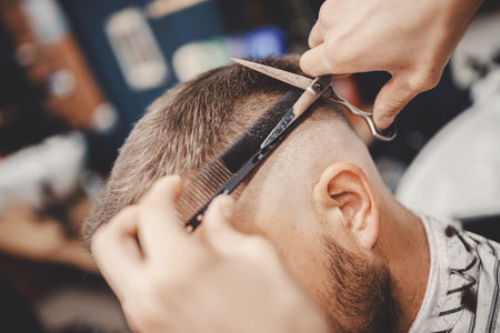 Close-up barber holds clip-on hair clipper barbershop