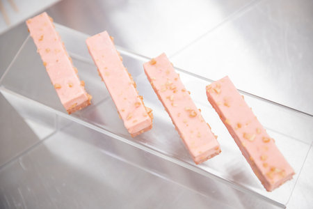 Close-ups of row cake buttercream brownies on display catering sweet table decoration matsの写真素材