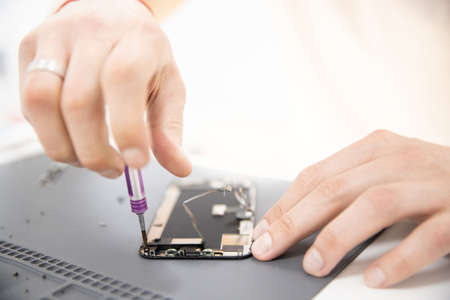 Mobile phone chip repair process, battery replacement and broken screen for recyclingの写真素材