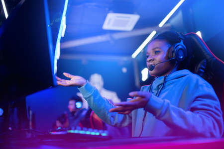 Facepalm Streamer African woman fail play gamer playing online video games computer emotions aggression, neon colorの写真素材