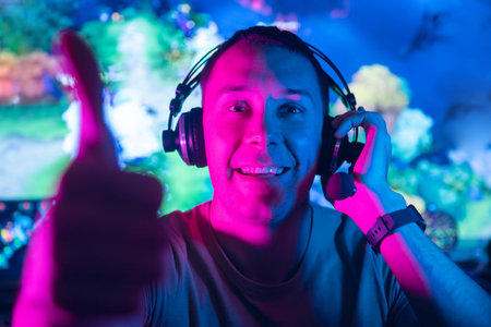 Happy professional cyber gamer man background online video game stream in neon color
