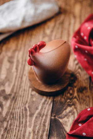 Chocolate chicken Easter symbol on dark wood backgroundの写真素材