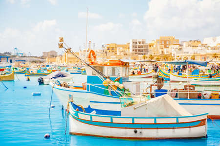 Fisherman port village in Marsaxlokk Malta. Mediterranean traditional retro colorful boats luzzu on summerの写真素材