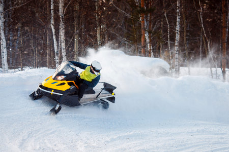 Snowmobile races jump in snow. Concept extreme winter sports