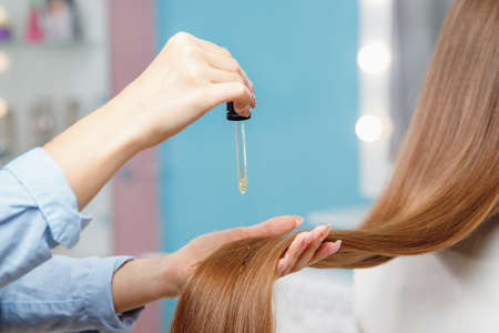 Close up Oil hair treatment for woman master in beauty salonの写真素材