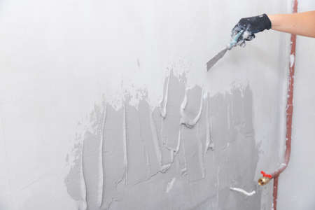 Preparing concrete wall in new house for plastering and leveling surfaceの写真素材