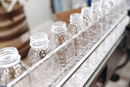 PET plastic bottles on a food automated line, milk and yoghurt bottling industry in dairy factoryの写真素材