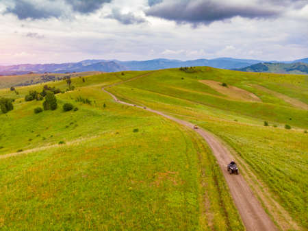 ATV rider rides through forest off-road in summerの写真素材