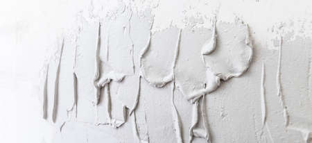 Banner Fresh wet plaster on walls before leveling, gray texture for apartment renovationの写真素材