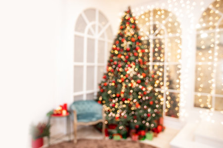 Blurred background Christmas interior with New Year tree and gifts in red, green colors