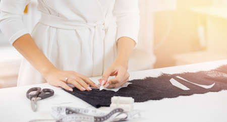 Banner for sewing workshop and tailoring. Seamstress marks sketch on clothes with chalkの写真素材