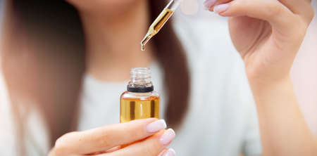 Banner woman hair care, drop of oil restore and recovery is applied to head bulbsの写真素材