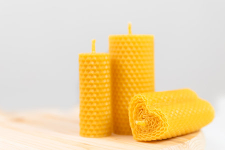 Yellow candles made of beeswax with smell of honey on white backgroundの写真素材