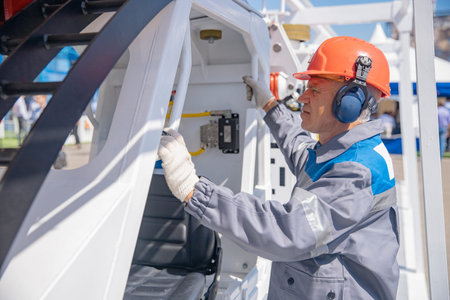 Miner engineer prepares to descend into ground on rail locomotive to mining