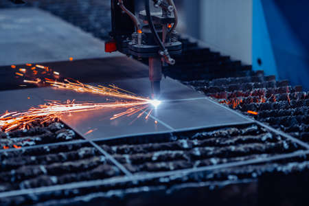 CNC plasma cutting metal iron material with sparks, industry backgroundの写真素材