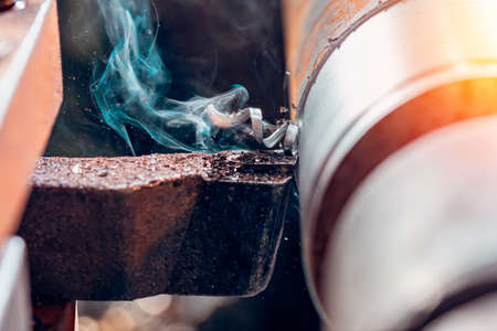 Macro machine iron tools CNC cut of metal with light spark, technology modern industrial.の写真素材