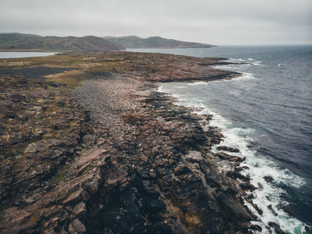 Rocky shore ocean beach, blue natural water background, fog autumn mood