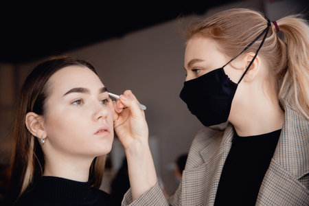 Eyebrow tint, master correction of brow hair women in beauty salon