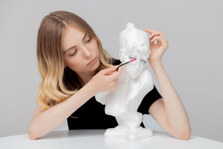 Young woman eyelash extension master uses brush. Home body care