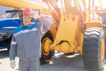 Driver yellow big truck on coal at open pit mining. Concept industry man workerの写真素材