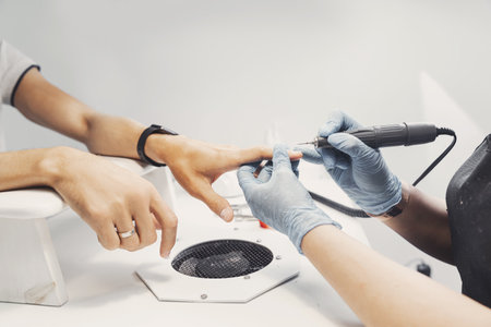 Professional manicure for man grinder machine in spa salonの写真素材