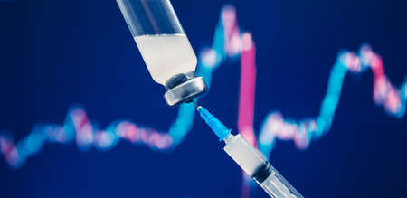 Vaccine vial dose coronavirus flu shot needle syringe. Concept impact of human medical vaccination on stock market economy finance exchangeの写真素材
