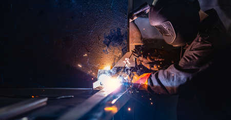 Industry banner, professional worker welder in protect mask use erecting technical iron at workの写真素材