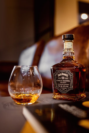 Russia - June 12. 2021, Glass bottle of Jack Daniels Tennessee whiskey on sunset wood toning backgroundのeditorial素材