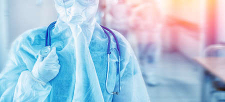 Doctors with phonendoscope in protective suits and masks in control red area covid 19. Concept banner medical clinic coronavirusの写真素材