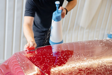Manual car wash, preparation of red body for pasting protective vinyl film